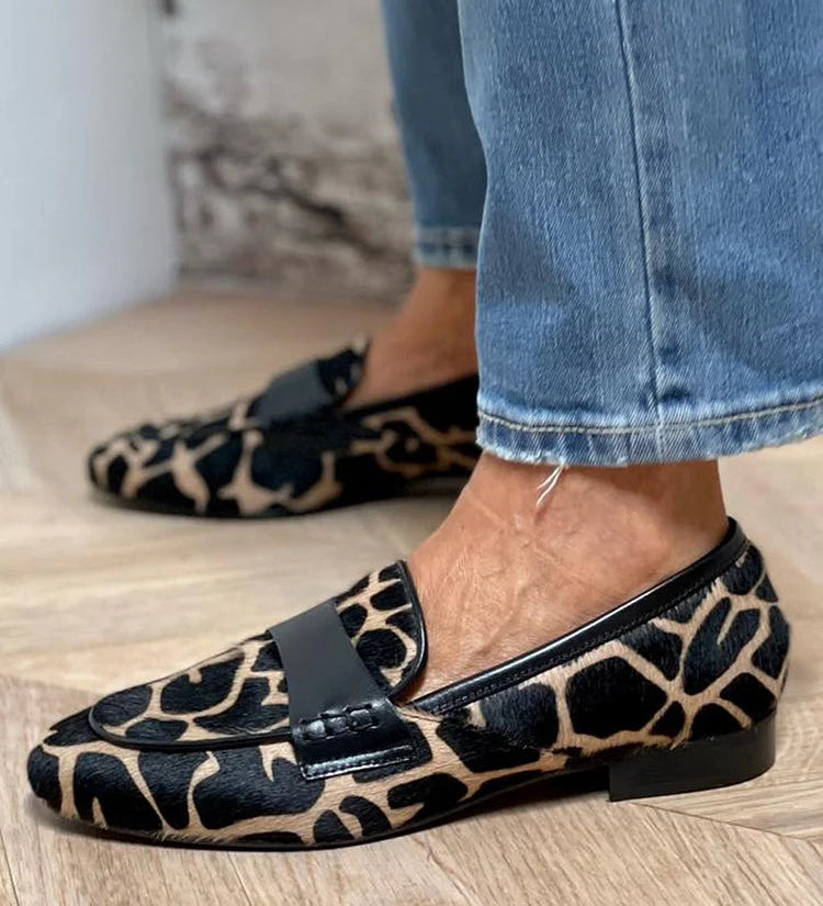 Ekskluzivni mokasini Nora z nizko peto, Alma Ljubljana, prikazani v elegantni črni barvi na beli podlagi.