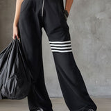 Retro športni jumpsuit Alma Ljubljana Renata, modro-črni športni kombinezon z vintage stilom, prikazan na sliki.