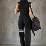 Retro športni jumpsuit Alma Ljubljana Renata, modre barve, s športnim krojem, prikazan na modelu