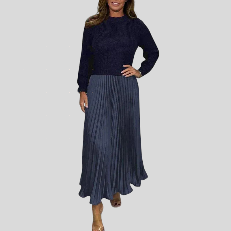 Gabriella plisirana obleka s puloverjem od Mila Ljubljana, podrobno prikazuje eleganten in moden stil obleke.